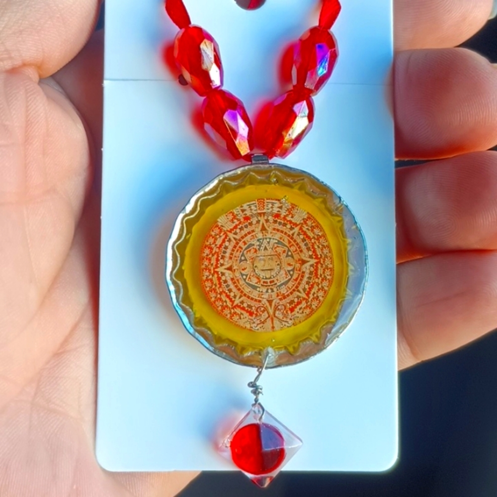Red and yellow handmade resin Aztec Calendar necklace